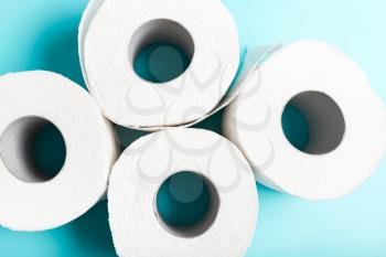 Four white toilet paper on a blue background