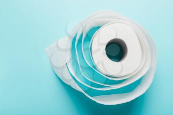  roll of white toilet paper on a blue background. Top view. The concept of hygiene, cleanliness