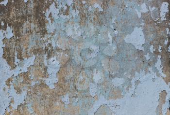 Blue, beige old grunge wall with peeled plaster