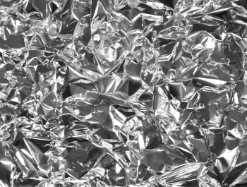 Silver foil vector background with shiny glare.