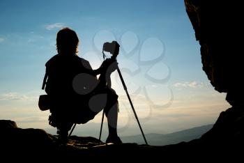 Silhouette of photographer in mountain. Element of design.