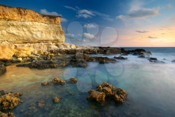 Beautiful seascape. Sea and rock at the sunset. Nature composition.
