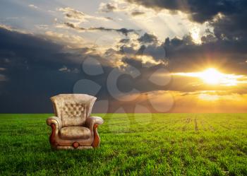 Chair on a green meadow. Concept design.