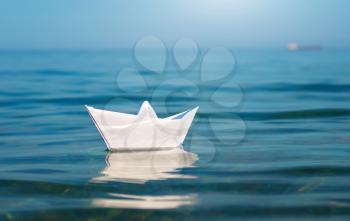 Paper toy ship and deep blue sea. Conceptual design.