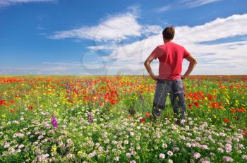 Man in spring meadow of flower. Conceptual scene.