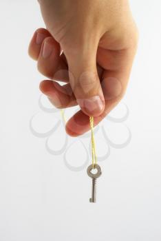 Hand holding a rope with a small key. Isolated object design.