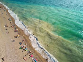 Aerial view at the beach. People relax on the sea shore. Beautiful natural seascape and summer time