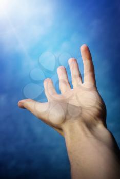 Hand to God. Conceptual design. Hand of a man reaching to towards sky