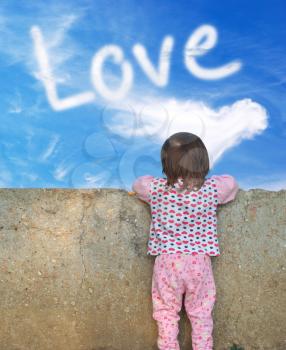 Little girl looking for a wall to the love sky . Conceptual design.
