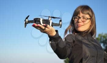 Drone landing on a woman hand palm. Element of design.
