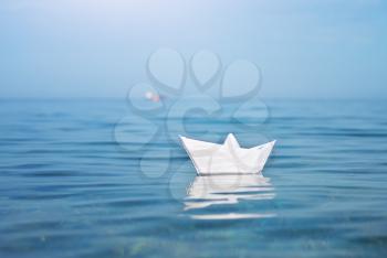Paper toy ship and deep blue sea. Conceptual design.