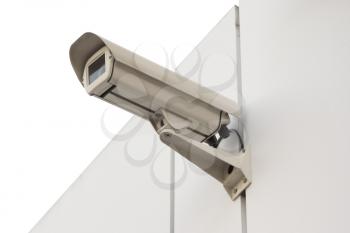 Security camera isolated on white wall. Isolated object.