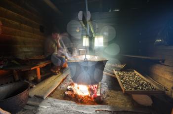Big pan copper kettle in hermitage. Hermit cooking into old house.