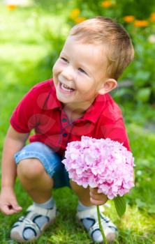 Little beautiful boy with flowers