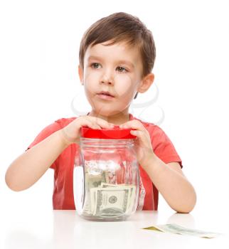 Cute boy with dollars, isolated over white
