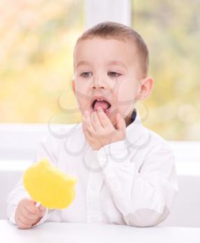 Happy little boy with big lollipop