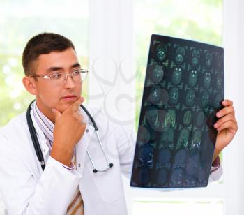 Young male doctor looking at tomography brain