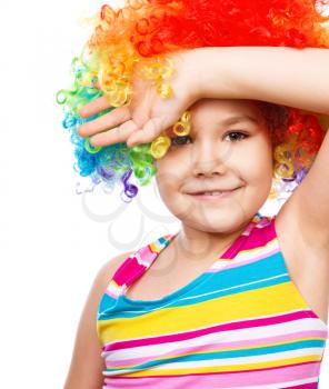 Cute girl in clown wig, isolated over white