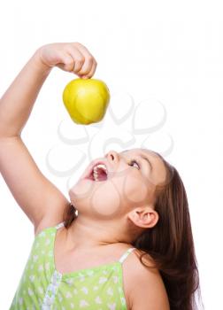 Portrait of a cute cheerful girl with green apple, isolated over white