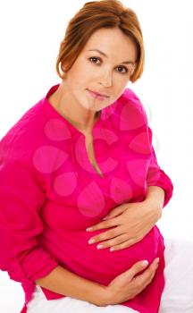 Image of pregnant woman touching her belly with hands, isolated over white