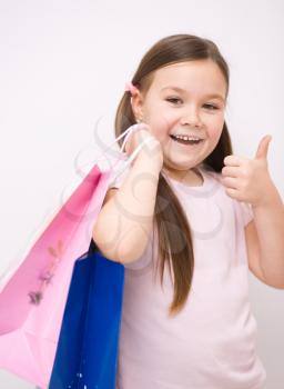 Cute little girl with colorful shopping bags