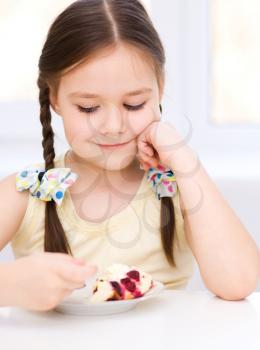 Cute little girl is eating ice-cream