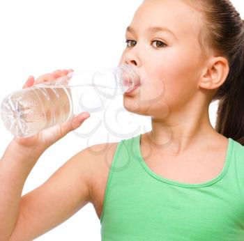 Cute little girl drinks water from a plastic bottle, isolated over white