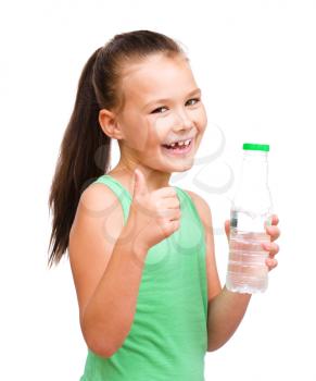 Cute little girl drinks water from a plastic bottle, isolated over white