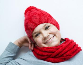 Cheerful smiling girl wearing a hat and scarf