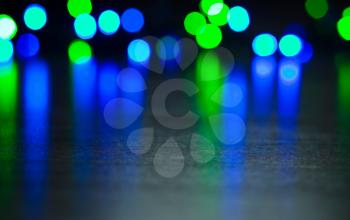 Festive defocused lights on a black background. Abstract background with glow