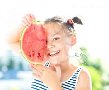 Cute girl is eating watermelon