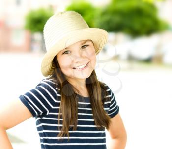 Portrait of a beautiful girl in a light hat