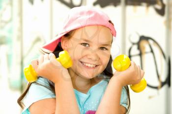Sport healthy lifestyle concept. Sporty childhood. Teenager exercising with dumbbells