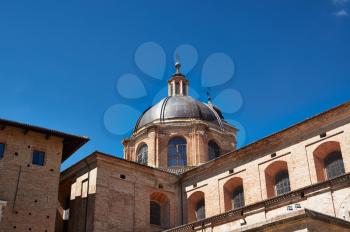 Details architecture of city Italia. Cathedral of red stone with delicate Windows and cone roof.