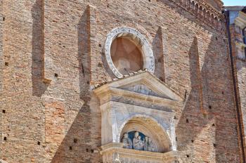 Details architecture of city Italia. Cathedral of red stone with delicate Windows and cone roof.