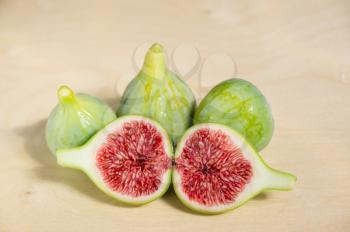 Large a few ripe figs on wooden table