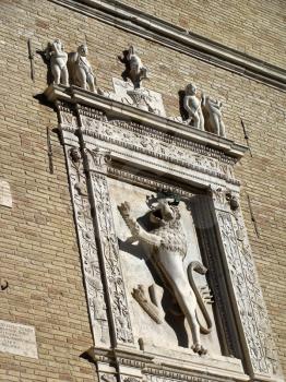 details of architecture, historical buildings of Italy. Stone walls and stone mask. Lion.
