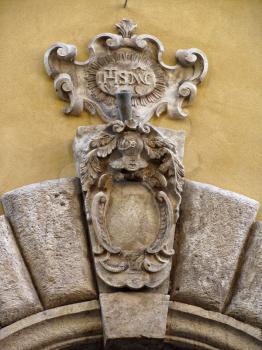 details of architecture, historical buildings of Italy. Stone walls and stone mask. Lion.