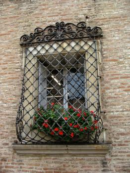 window with stained glass in an old Italian house. Architectural details.