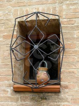 Brown varnish window in an old Italian house. Architectural details.
