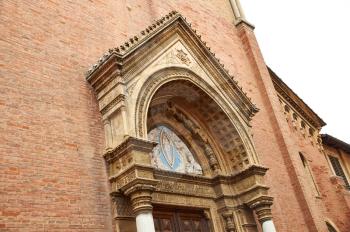 Details architecture of city Senigallia. Cathedral of red stone with fishnet Windows and cone roof. architecture details