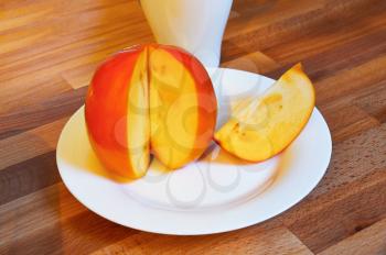 Asian juicy orange persimmon closeup on a wooden table