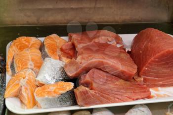 Fresh tuna, salmon of Mediterranean cooking  on the shelves, the tables of the fish market
