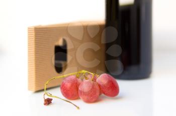 Glowing ripe berries of red grapes on white background