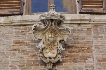 details of architecture, historical buildings of Italy. Stone walls and stone mask. Castelli di Jesi. Marche.