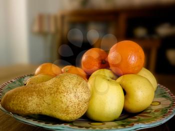 Fruit closeup on wooden vintage table. Oranges and pear.