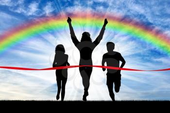 Runners, rainbow, sport. Winning runner crosses the red tape on the background of the rainbow