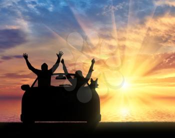 Travel and freedom. Happy people in the car on the shore of the sea sunset