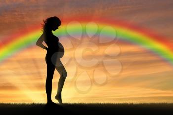Pregnant women. Pregnant woman on the background of the rainbow