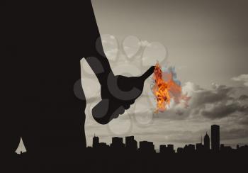 Terrorist concept. Silhouette of a terrorist holding a molotov cocktail on the background of the city